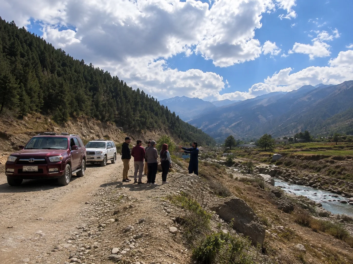 Travelers and an Afghan guide stopping on a mountain road