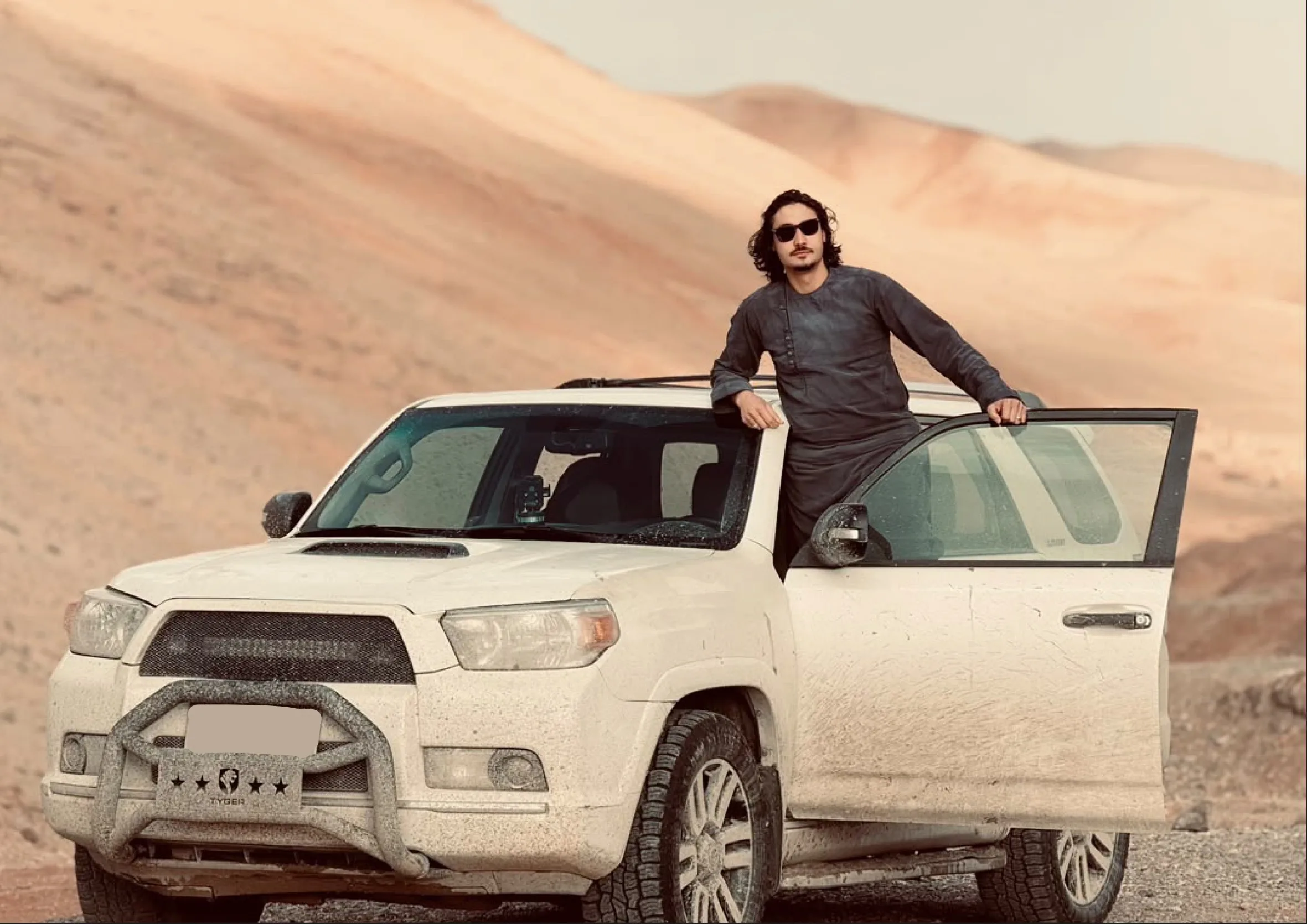 AfghanTours guide beside a four wheel drive vehicle